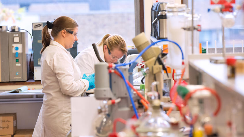 Students working in a lab surrounded by equipment.