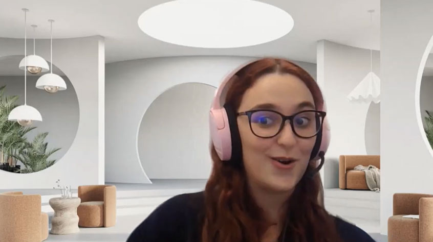 Woman wearing pink headphones with a Teams style background, looking into the camera.