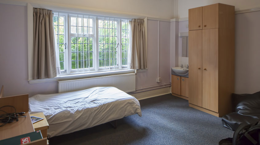 A single bedroom with a washbasin