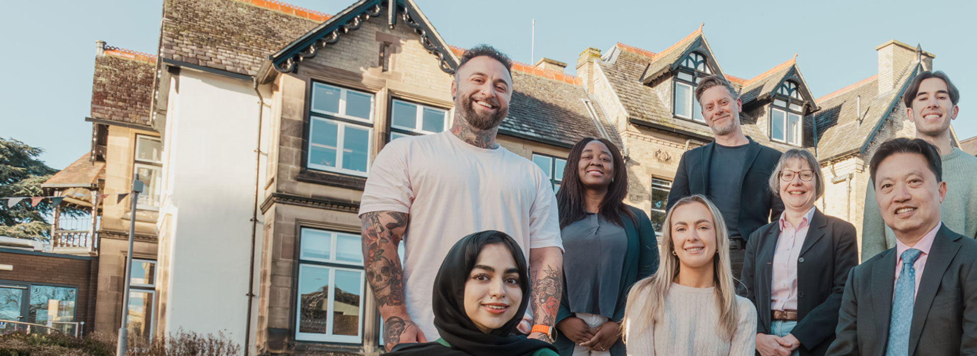 Students standing outside the Village in Oadby, posing for the camera.