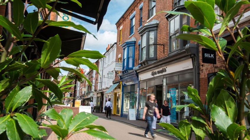 People walking in Leicester city centre on a sunny day.