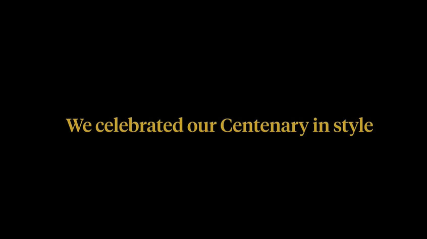 Gold writing on a black screen which reads: we celebrated our centenary in style