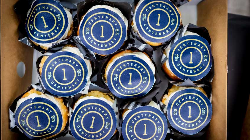 Collection of cupcakes with the centenary logo on them