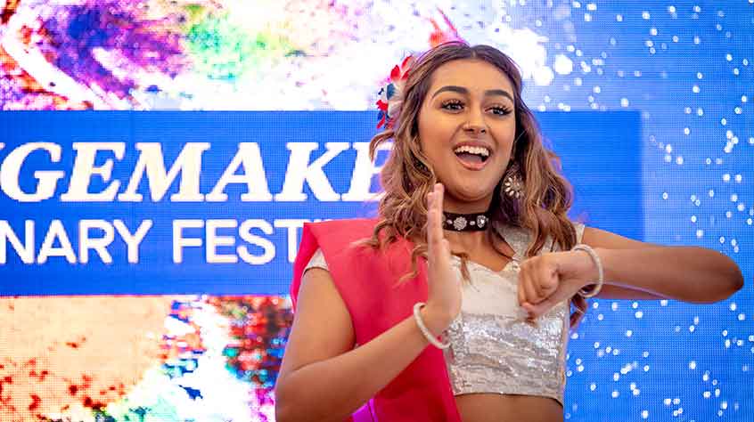 2/10/2021 - a dancer wearing a red and white sari performs at the ChangeMakers Centenary Festival