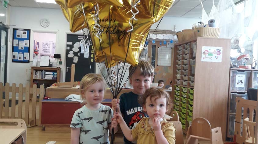 Children at the University of Leicester nursery holding balloons