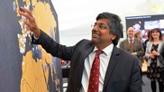 4/10/21 - VC Nishan Canagarajah puts a pin in a giant world map as part of our centenary celebrations, celebrating the Univeristy's global community.