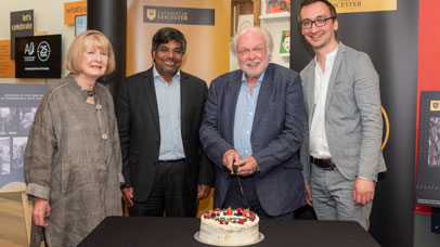 Michael Attenborough cutting cake with Nishan Canagarajah and Andrew Fletcher