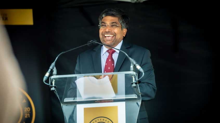 VC Nishan at the podium making a speech about the centenary launch