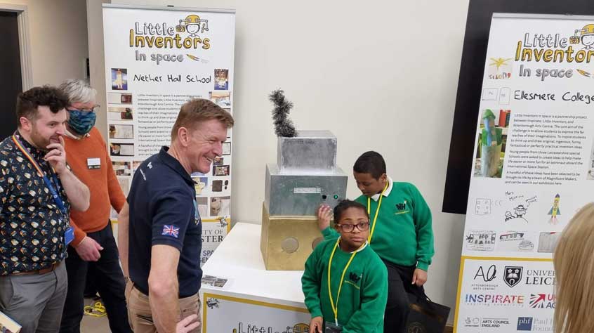 Major Tim Peake being shown the work of local schoolchildren, created for the’ Little Inventors in Space’ scheme.