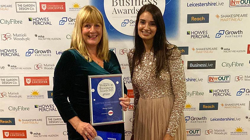 Dr Navdeep Athwal (right) presents the Lifetime Achievement award to Penny Coates (left) at the LeicestershireLive Women in Business Awards 2021