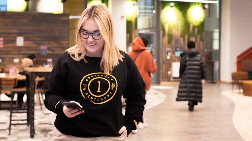 Person wearing a centenary branded sweatshirt