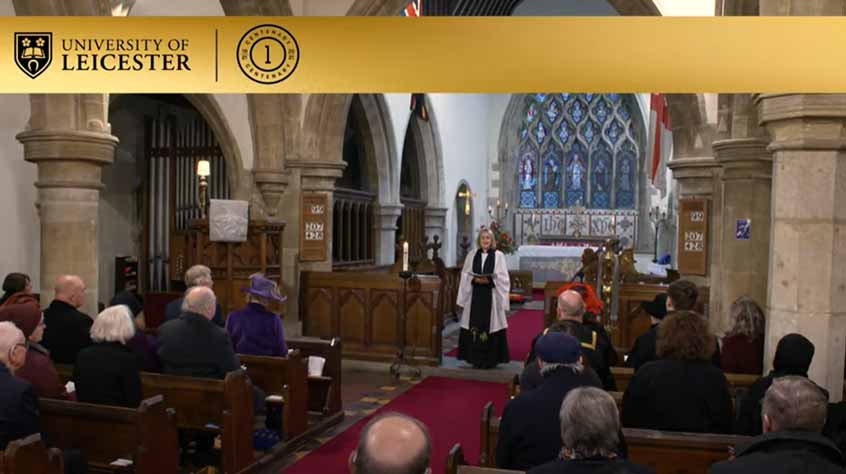 People in a church, with the vicar speaking