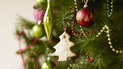 Close up of christmas tree with baubles and christmas biscuits