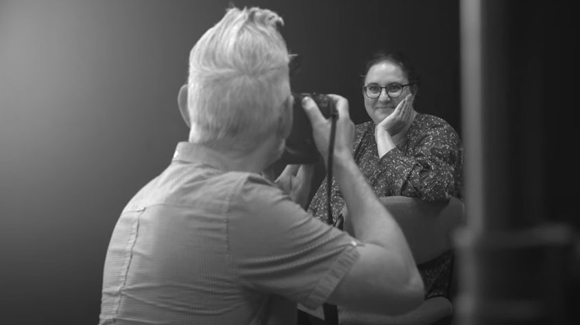 Person being photographed in a studio