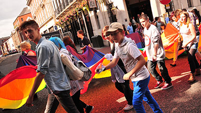 marchers with rainbow flag