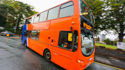a bus in motion between halls and campus