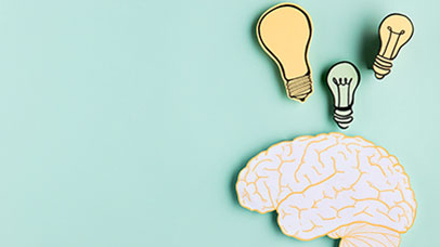 Photo of paper lightbulbs and brain