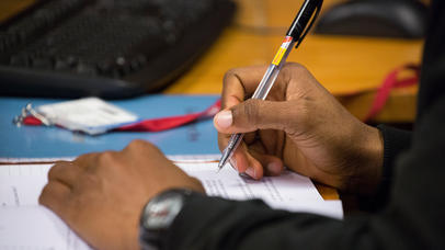 Student hands writing