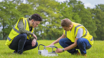 Two men using Geology equipment