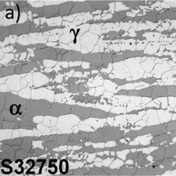 A micrograph showing equiaxed grains in two different shades of grey. The different shades are arranged in thick bands 