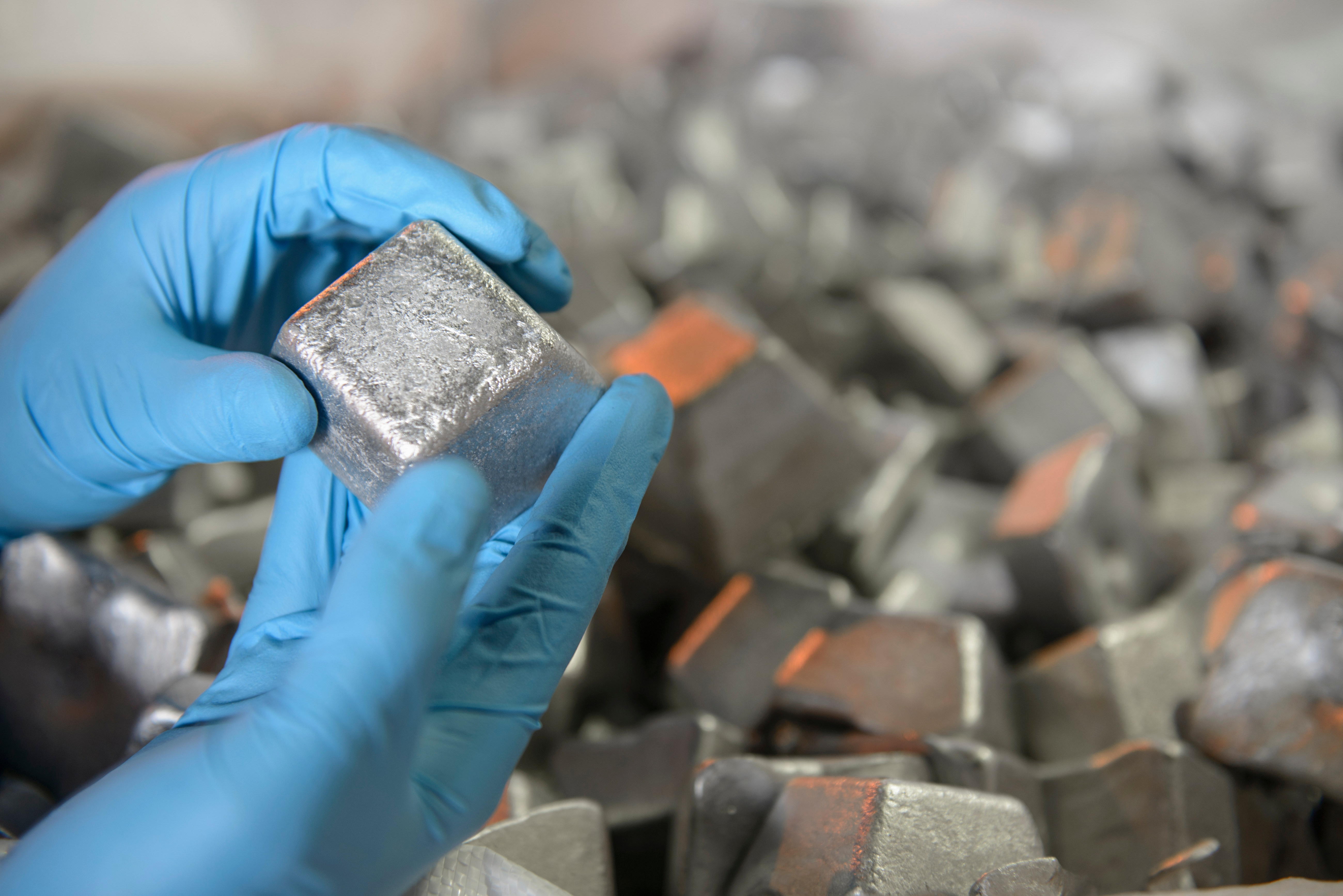 A person holding metallic material for inspection. 