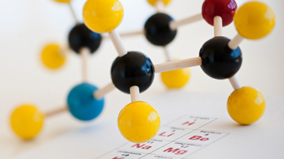 Molecule model on a periodic table.