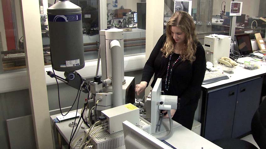 female working on an electron microscope