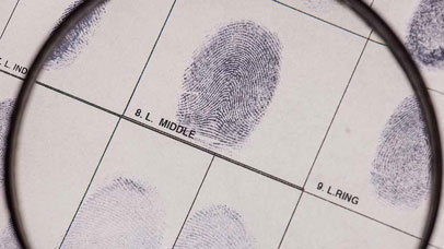 Magnifying glass over a fingerprint.