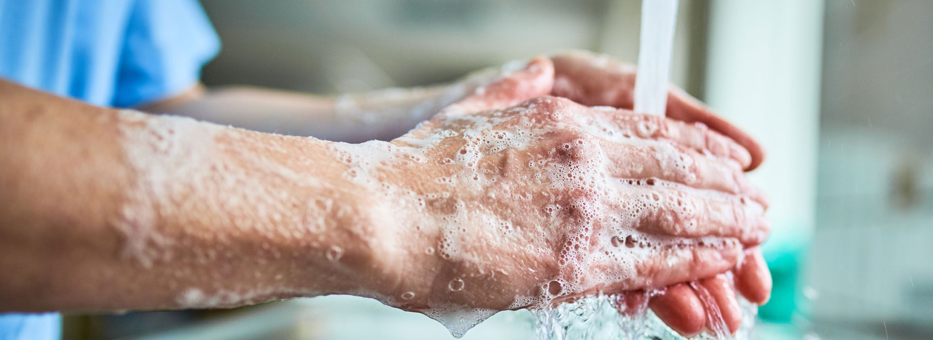 Healthcare person washing their hands.