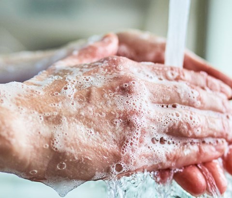 Healthcare person washing their hands.