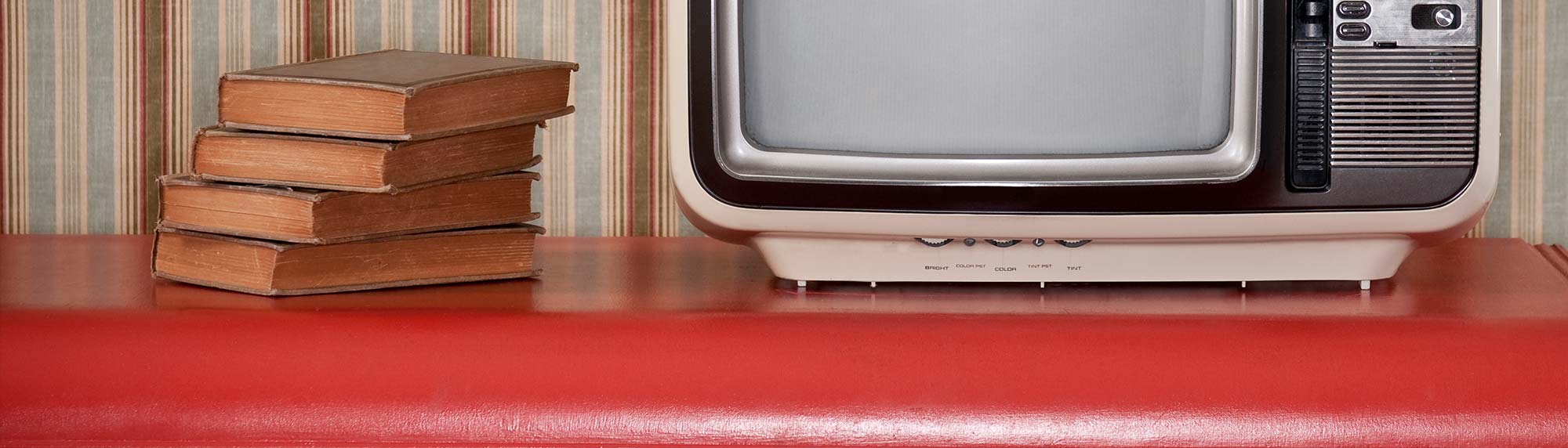 tv and books on a table
