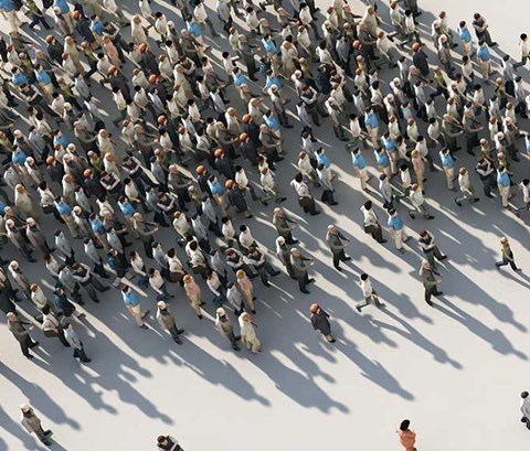 abstract image of a large group of people passing through a chackpoint