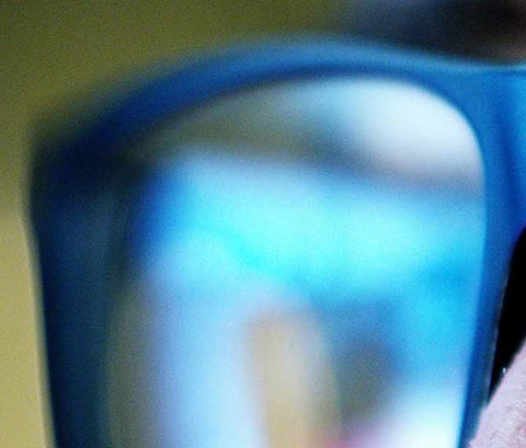 close up shot of someone wearing glasses looking at a screen