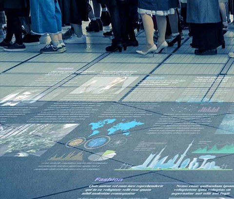 abstract image of news projected onto the floor alongside a queue of people