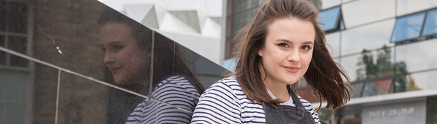 smiling student sitting outside the library