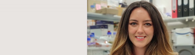 smiling student working in a lab