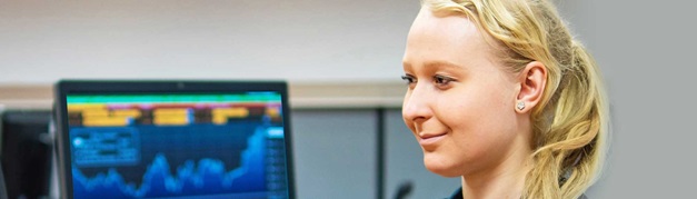 smiling student sat in a computer room