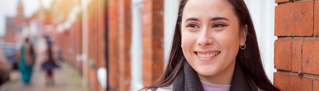 student stood outside on a residential street