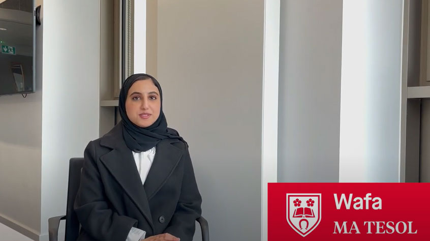 Student Wafa sitting on a chair talking to the camera about her course