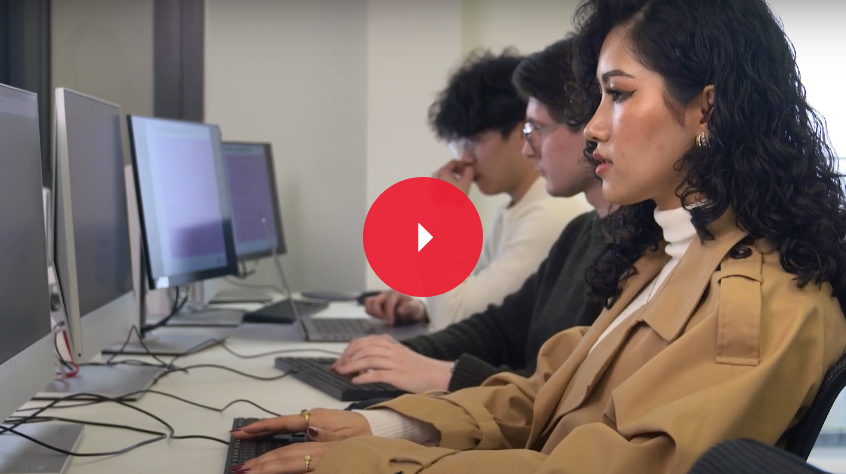 three students working on the computers