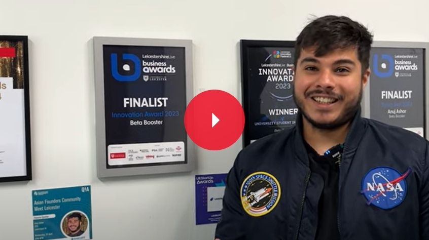 An image of Engineering Alumni Anuj smiling at the camera. He stands next to his finalists certificate. 
