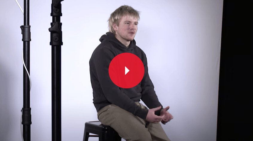 Jude sitting and talking in a filming studio 