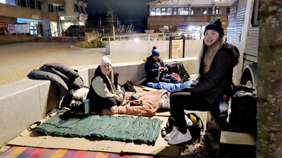 Volunteers sitting in Centenary Square, participating in the Big Sleep 2023