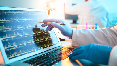 Person in a lab interacting with data on a laptop