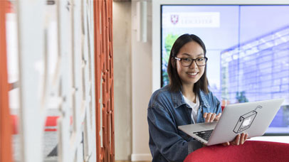 A student holding a laptop
