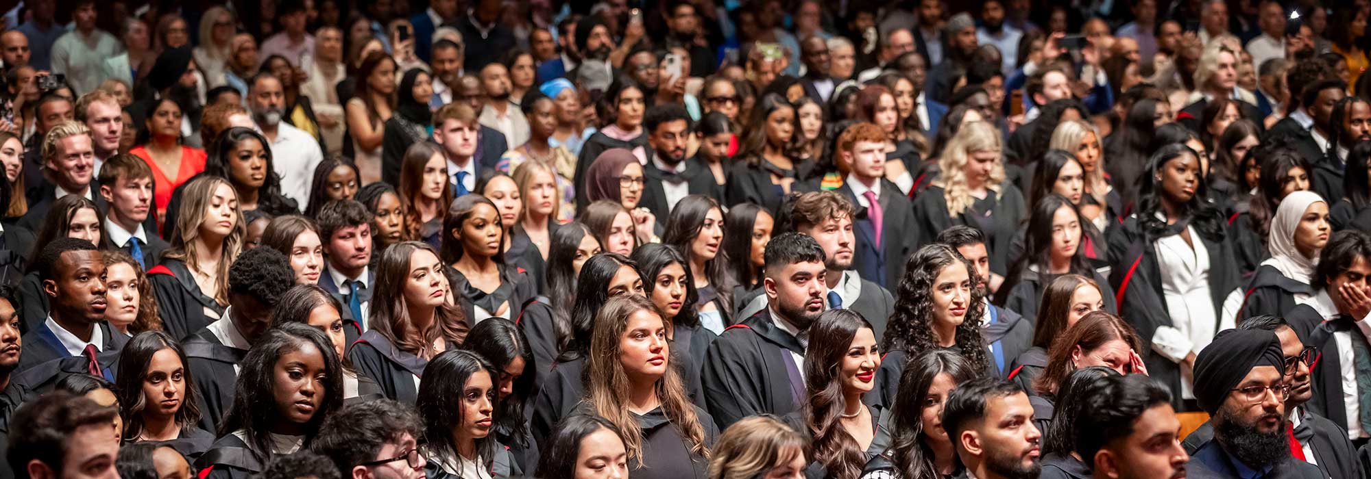A congregation of graduating University of Leicester students at De Montfort Hall