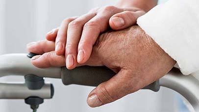 an elderly persons hand being assisted