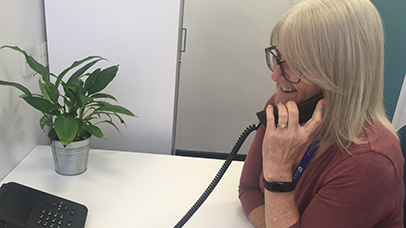 Photo: Leicester Clinical Trial staff member answering phone for the unit