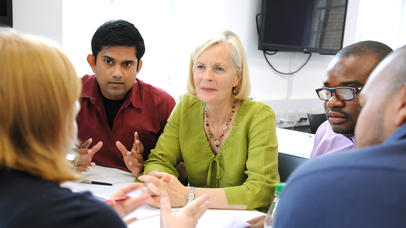 Photo: Clinical Trials Collaboration meeting between several individuals at meeting table