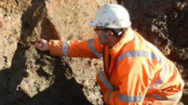 Wayne Jarvis in a high vis jacket brushing a wall